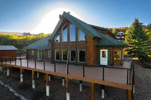 View of side of property featuring a wooden deck