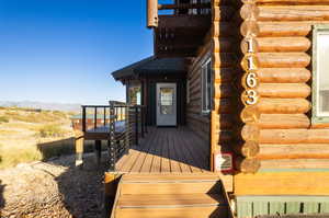 Doorway to property with a deck with mountain view