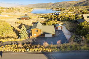 Birds eye view of property with a water and mountain view