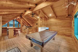 Playroom featuring lofted ceiling with beams, rustic walls, light hardwood / wood-style flooring, billiards, and wood ceiling