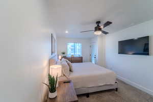 Bedroom with ceiling fan and carpet flooring