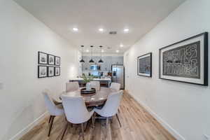 Dining room featuring sink and light hardwood / wood-style flooring