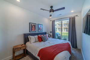 Bedroom featuring dark colored carpet, ceiling fan, and access to exterior