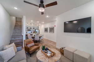 Living room with hardwood / wood-style flooring, ceiling fan, and sink