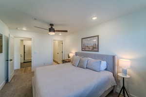 Carpeted bedroom featuring ceiling fan