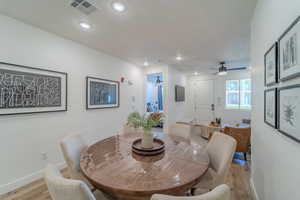 Dining room with light hardwood / wood-style flooring and ceiling fan