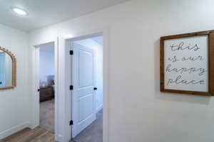 Corridor with hardwood / wood-style flooring