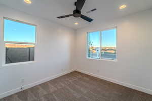 Empty room featuring ceiling fan and carpet