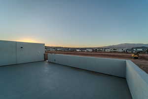 Patio terrace at dusk with a mountain view