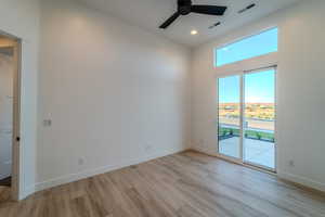 Spare room featuring ceiling fan and light hardwood / wood-style floors