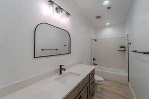 Full bathroom featuring shower / washtub combination, vanity, and toilet