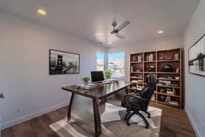 Office with ceiling fan and dark hardwood / wood-style floors