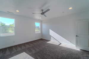 Empty room featuring carpet floors and ceiling fan