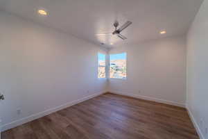 Unfurnished room featuring ceiling fan and wood-type flooring