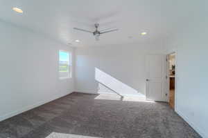 Empty room featuring carpet floors and ceiling fan