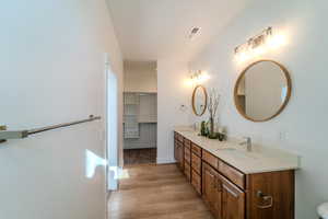 Bathroom featuring dual vanity and hardwood / wood-style floors