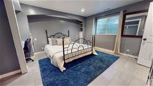 Bedroom with light tile floors