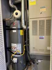 Utility room featuring secured water heater and heating utilities