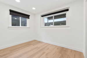 Empty room with light hardwood / wood-style floors