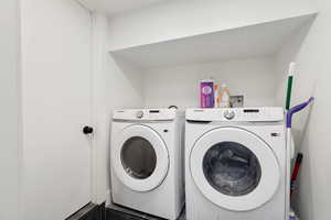 Clothes washing area featuring independent washer and dryer and hookup for a washing machine