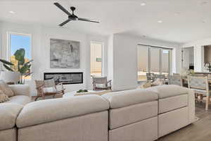 Living room featuring ceiling fan and light wood-type flooring