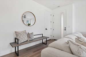 Living room with dark hardwood / wood-style flooring