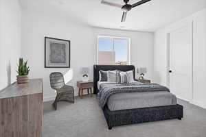 Bedroom featuring ceiling fan and carpet