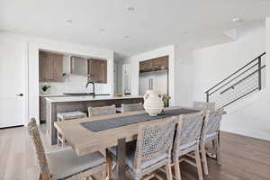 Dining room with sink and light wood-type flooring