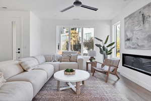 Living room with wood-type flooring and ceiling fan