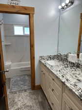 Master Bathroom featuring LVPflooring, shower / bathing tub combination, and vanity