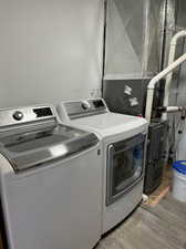 Laundry area with LVP floors and washer and dryer