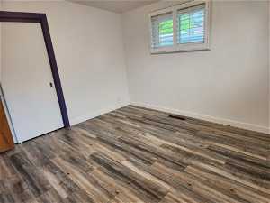 Spare room featuring dark hardwood / wood-style floors