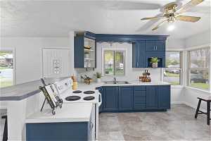 Kitchen featuring blue cabinetry, and light tile floors