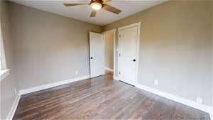 Unfurnished bedroom featuring wood-type flooring and ceiling fan