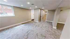 Interior space with carpet floors and a textured ceiling