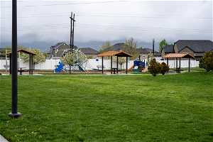 Exterior space featuring a lawn, a playground, and a gazebo