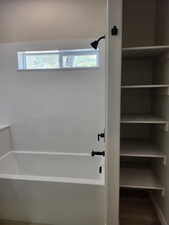 Master bath rm. soaking tub  with shower and wood-type flooring