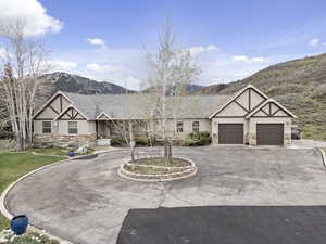 View of front of home with a mountain view and a garage