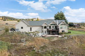 Rear view of house with a patio and a deck