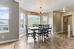 Tiled dining area with a healthy amount of sunlight and a notable chandelier