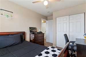 Bedroom with carpet, ceiling fan, and a closet