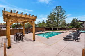 View of pool featuring a patio and a pergola