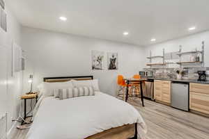 Bedroom featuring sink and light hardwood / wood-style floors