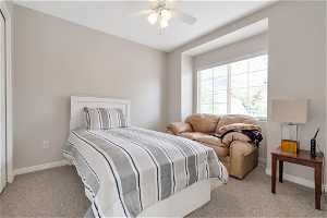 Bedroom with ceiling fan and carpet floors