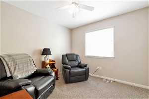 Sitting room with carpet flooring and ceiling fan