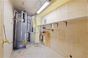 Utility room with gas water heater and laundry hookups