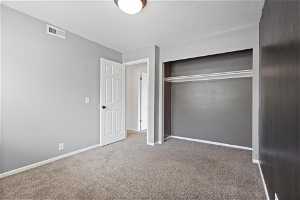 Second bedroom featuring a closet and carpet flooring