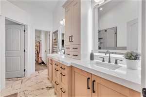 Bathroom with walk in shower, vaulted ceiling, dual vanity, and tile flooring