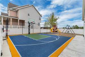 View of basketball court with a playground