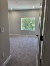 2 nd bedroom featuring a textured ceiling and carpet floors